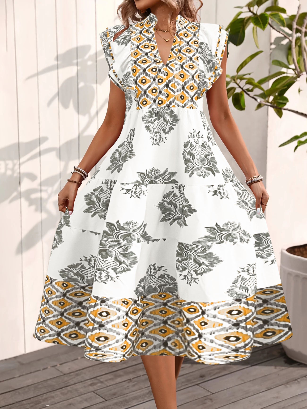 Women's dress – Flared flowing cut – High collar – Flutter sleeves – Floral and geometric patterns